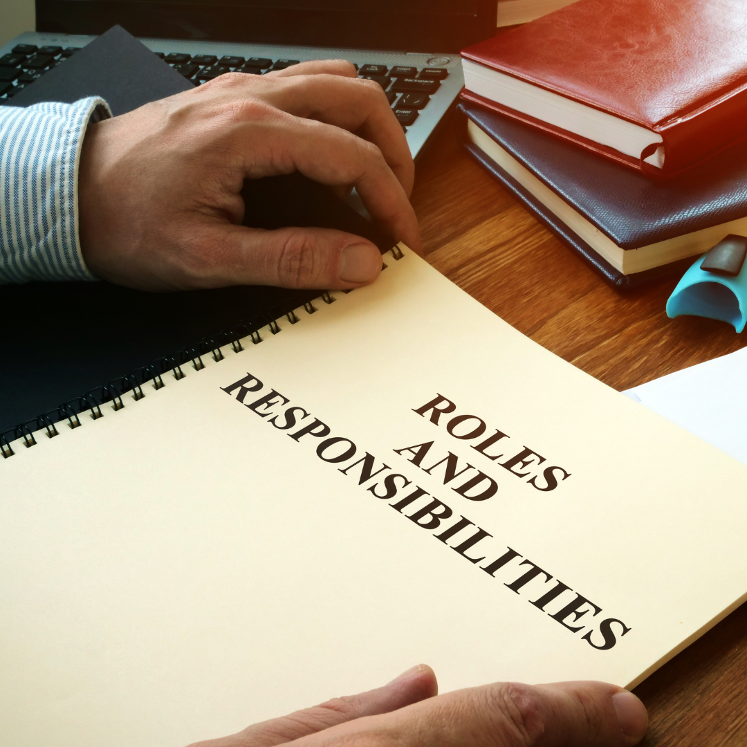 Book titled 'Roles and Responsibilities' on a desk, symbolizing the key differences between facial specialists and estheticians.
